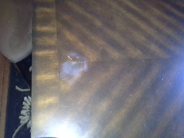White Spot on a Variegated Wooden Table